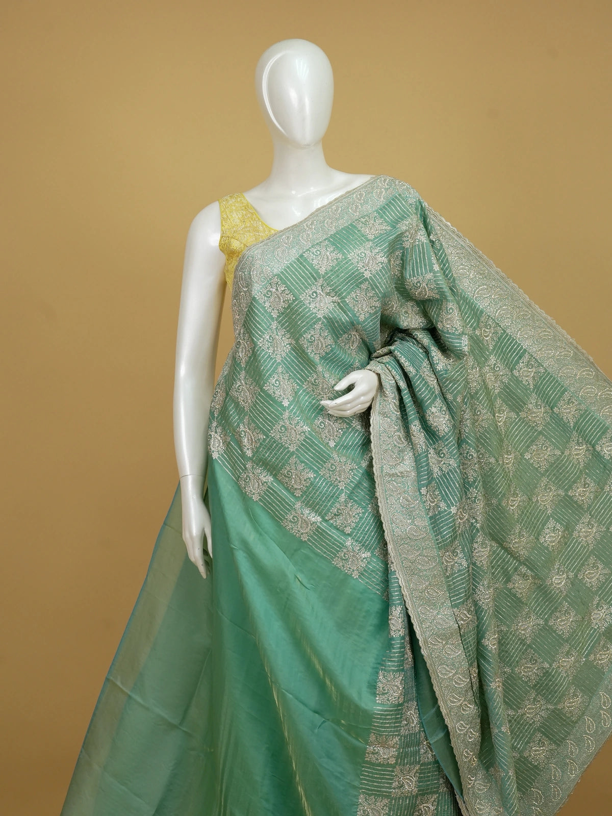 Sea green designer organza saree with silver zari and sequin paisley embroidery and embellished border