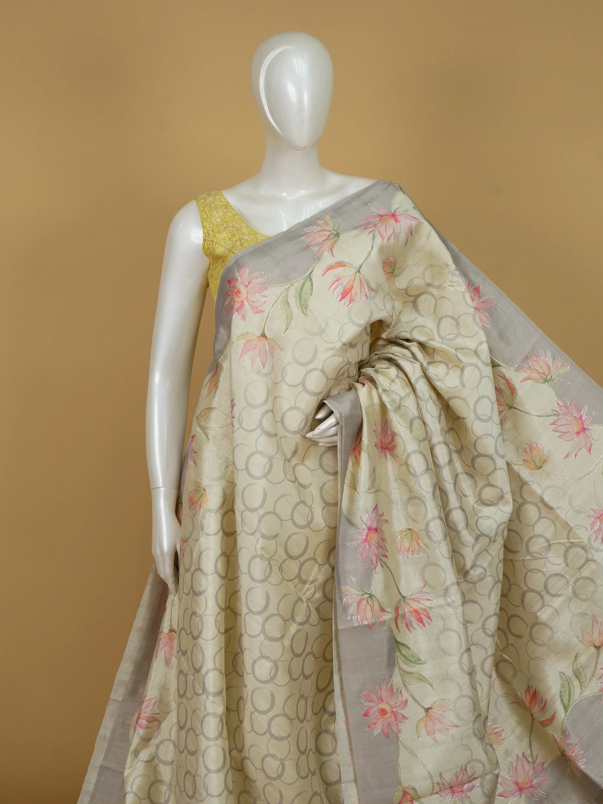 Cream and grey art silk designer saree with hand-painted lotus florals, silver outlining and a contrast grey border