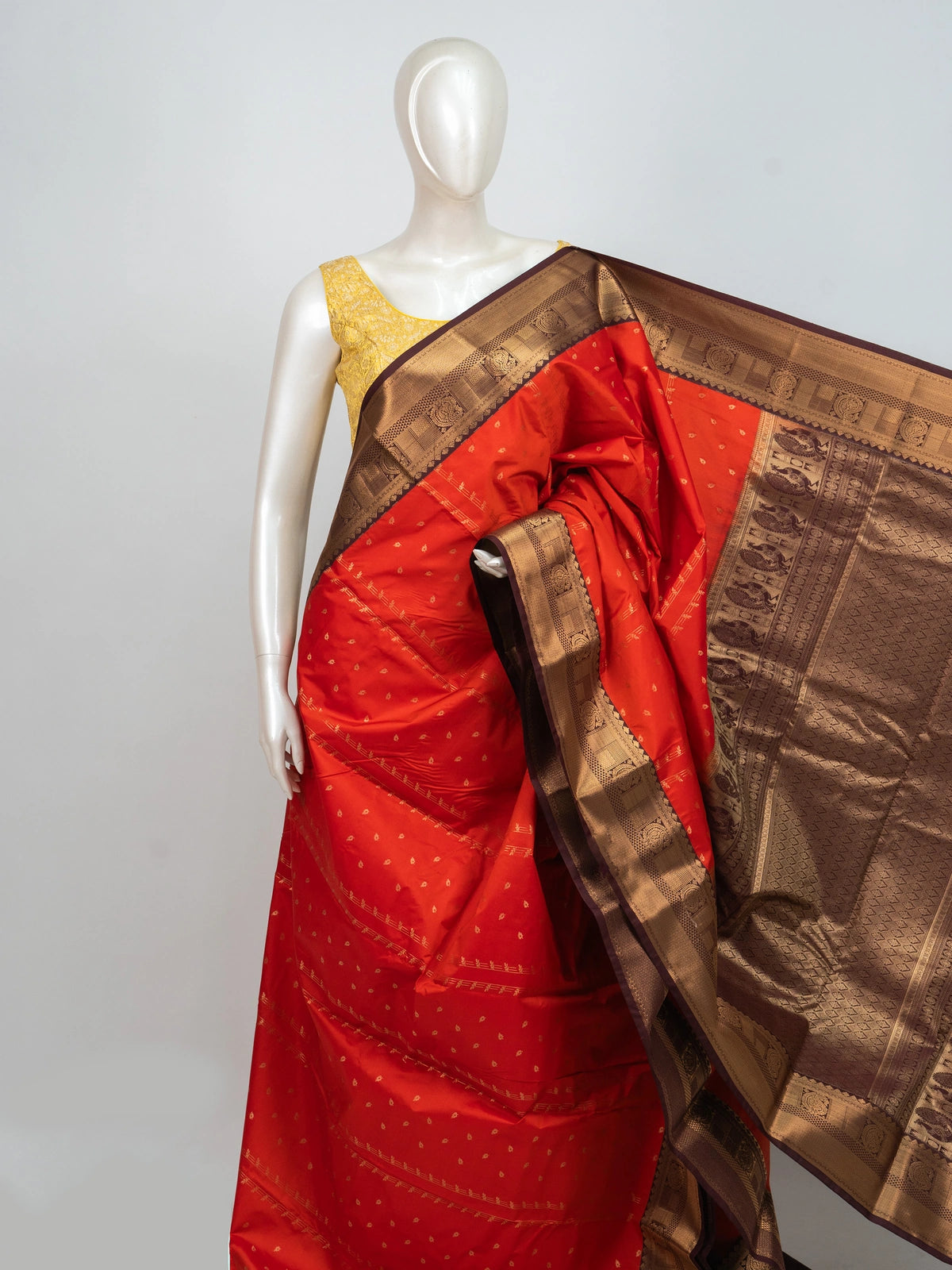 Orange semi silk saree with maroon contrast border and gold zari peacock pallu