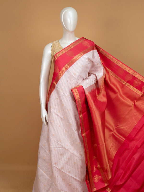 White and rani pink pure Kanchipuram silk saree with checked body, gold zari buttis and contrast zari border