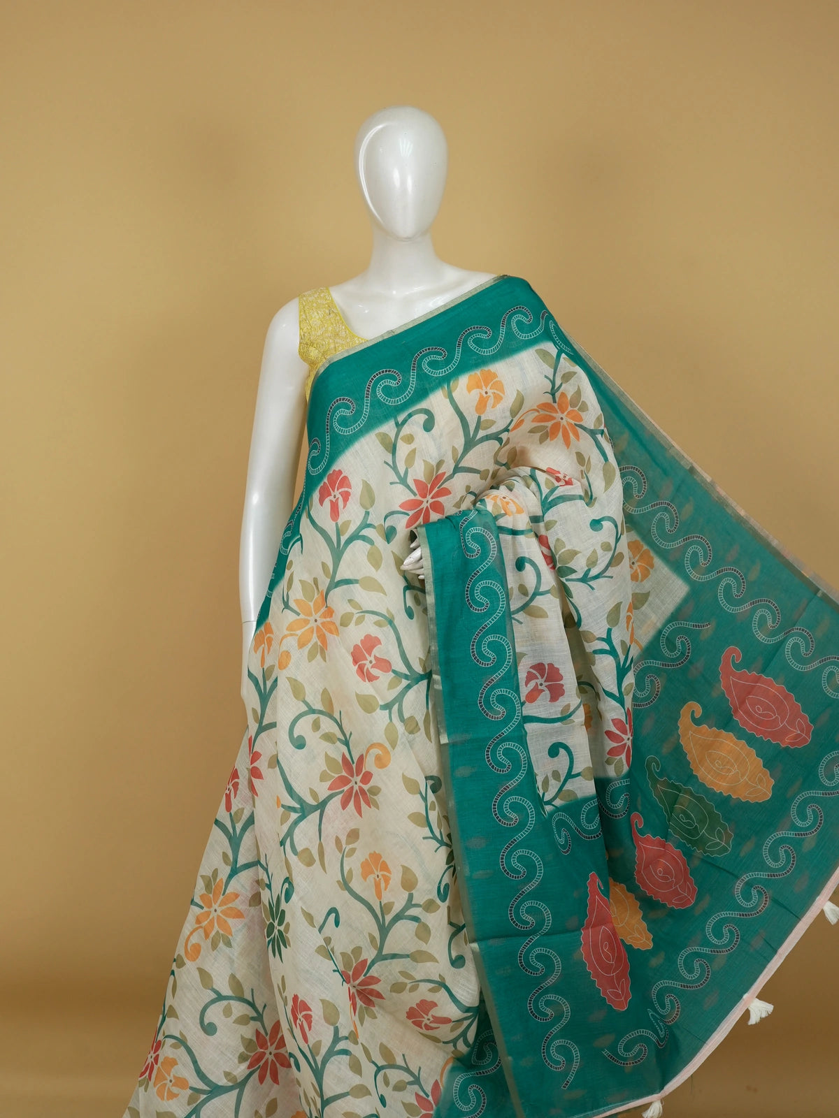 Cream linen cotton saree with multicolour floral print and contrast teal green paisley border