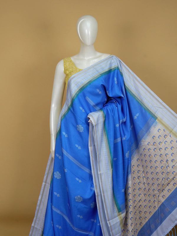 Blue Dola silk saree with white floral buti motifs and contrast zari border