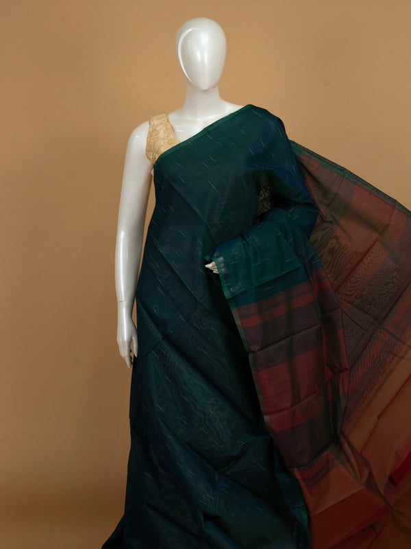 Teal green silk cotton saree with silver zari streaks and contrast maroon striped pallu