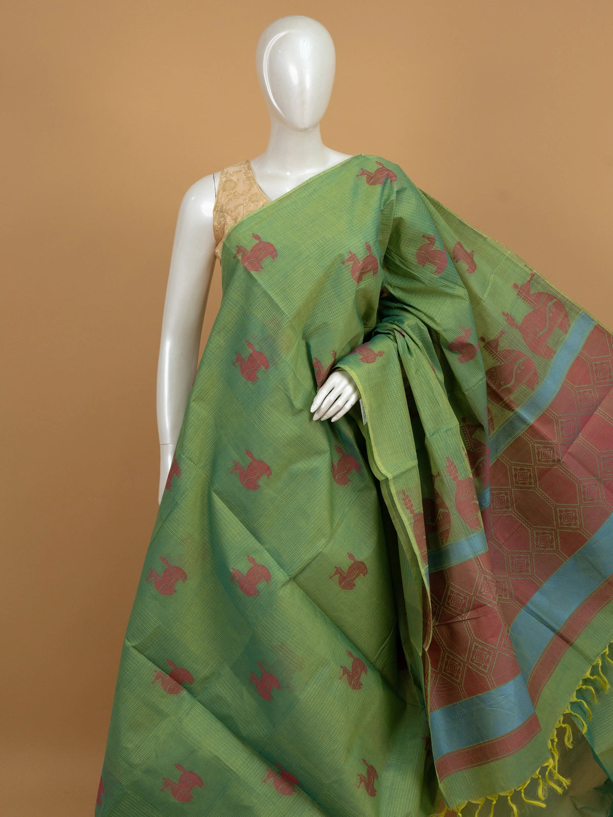 Green silk cotton saree with pink animal motifs and contrast blue-pink border