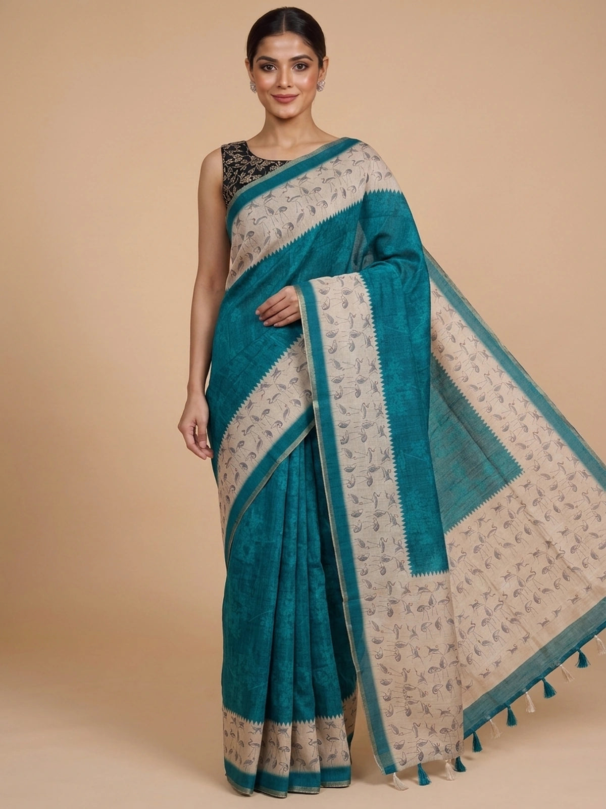 Teal linen cotton saree with cream crane-motif contrast border and temple-style edging