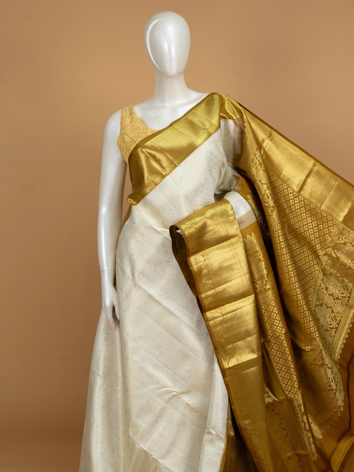 Cream pure Kanchipuram silk saree with gold zari floral and peacock border and pallu