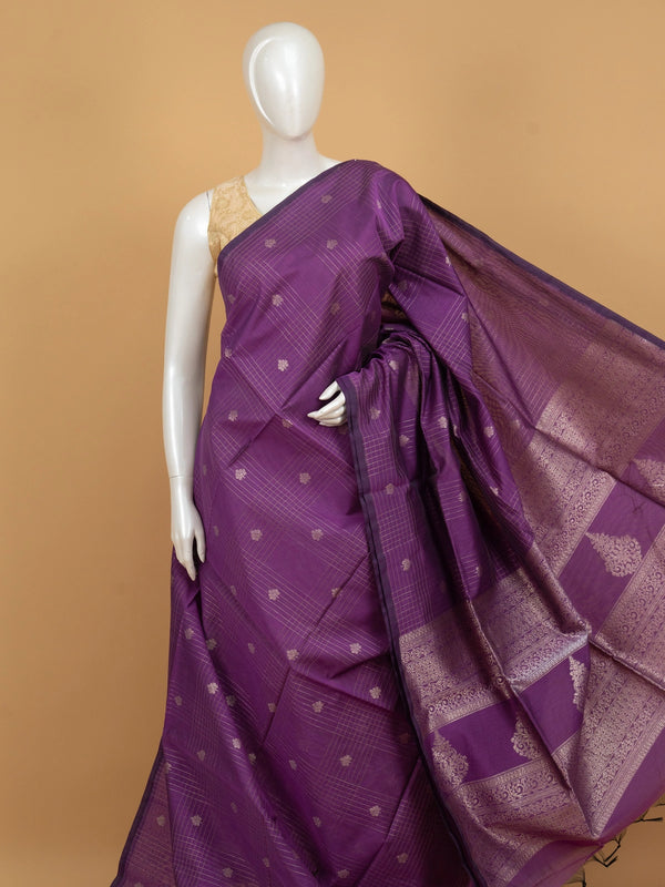 Purple silk cotton saree with silver zari checks, floral buttas and ornate woven border