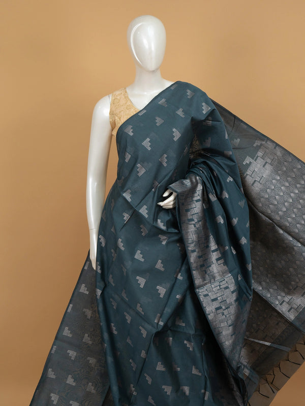 Teal blue silk cotton saree with silver zari geometric motifs and patterned pallu