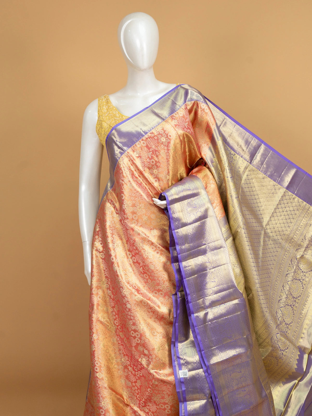 Peach orange pure Kanchipuram silk saree with floral gold zari body and contrast purple border