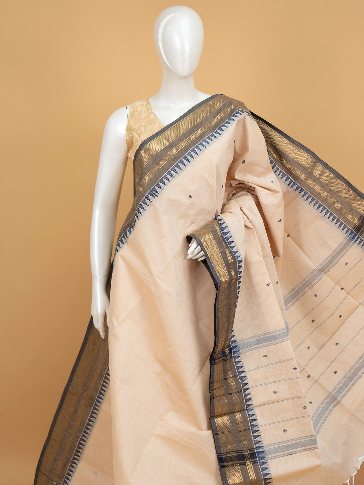 Cream Chettinad cotton saree with navy blue temple border and gold zari