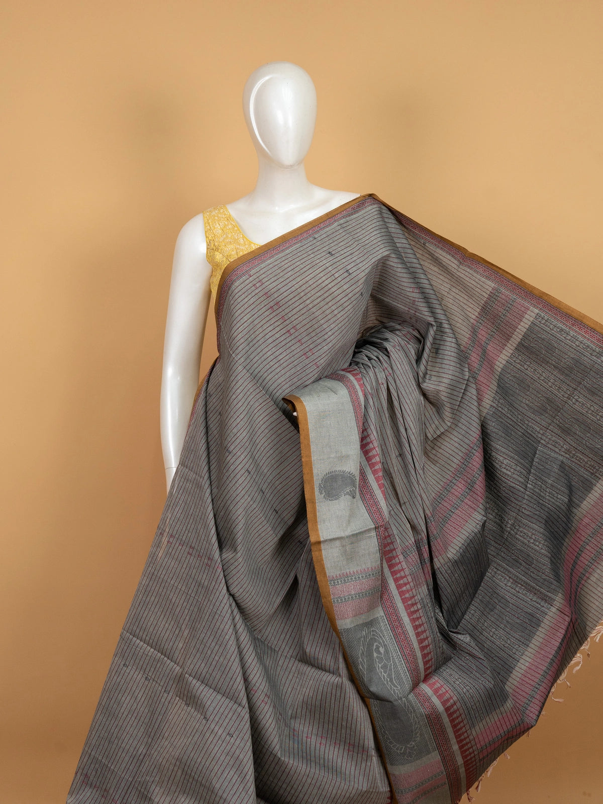 Grey linen cotton saree with maroon pinstripes, mustard contrast border, and paisley woven pallu