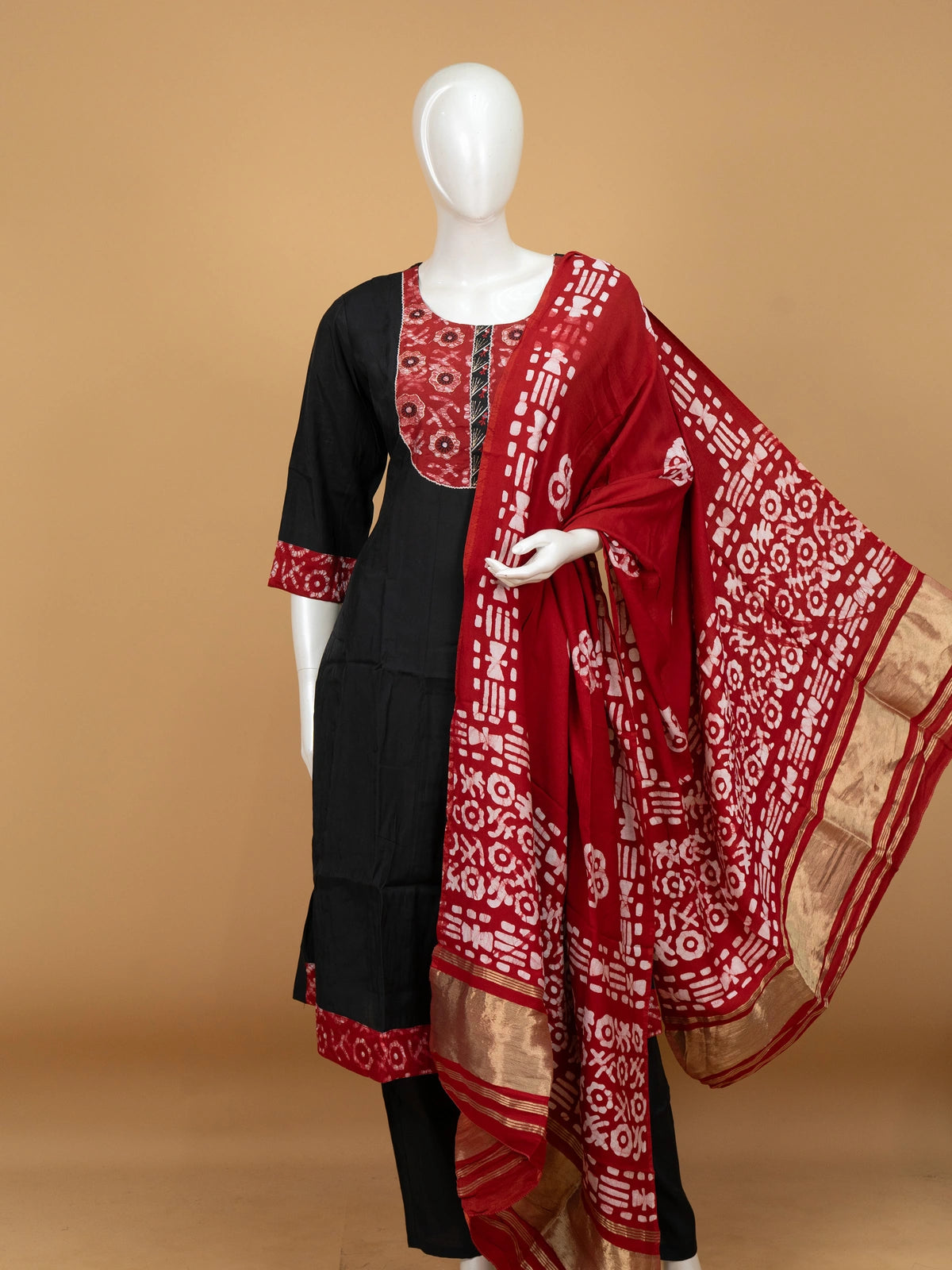 Black A-line cotton kurti set with red batik-print yoke and zari-bordered dupatta
