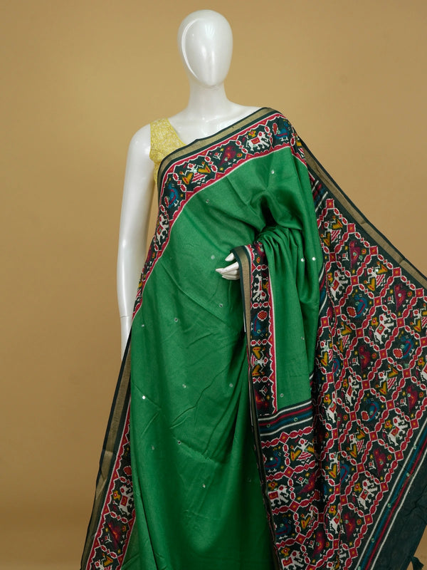 Green linen cotton saree with red patola ikat border, mirror work and multicolour pallu motifs