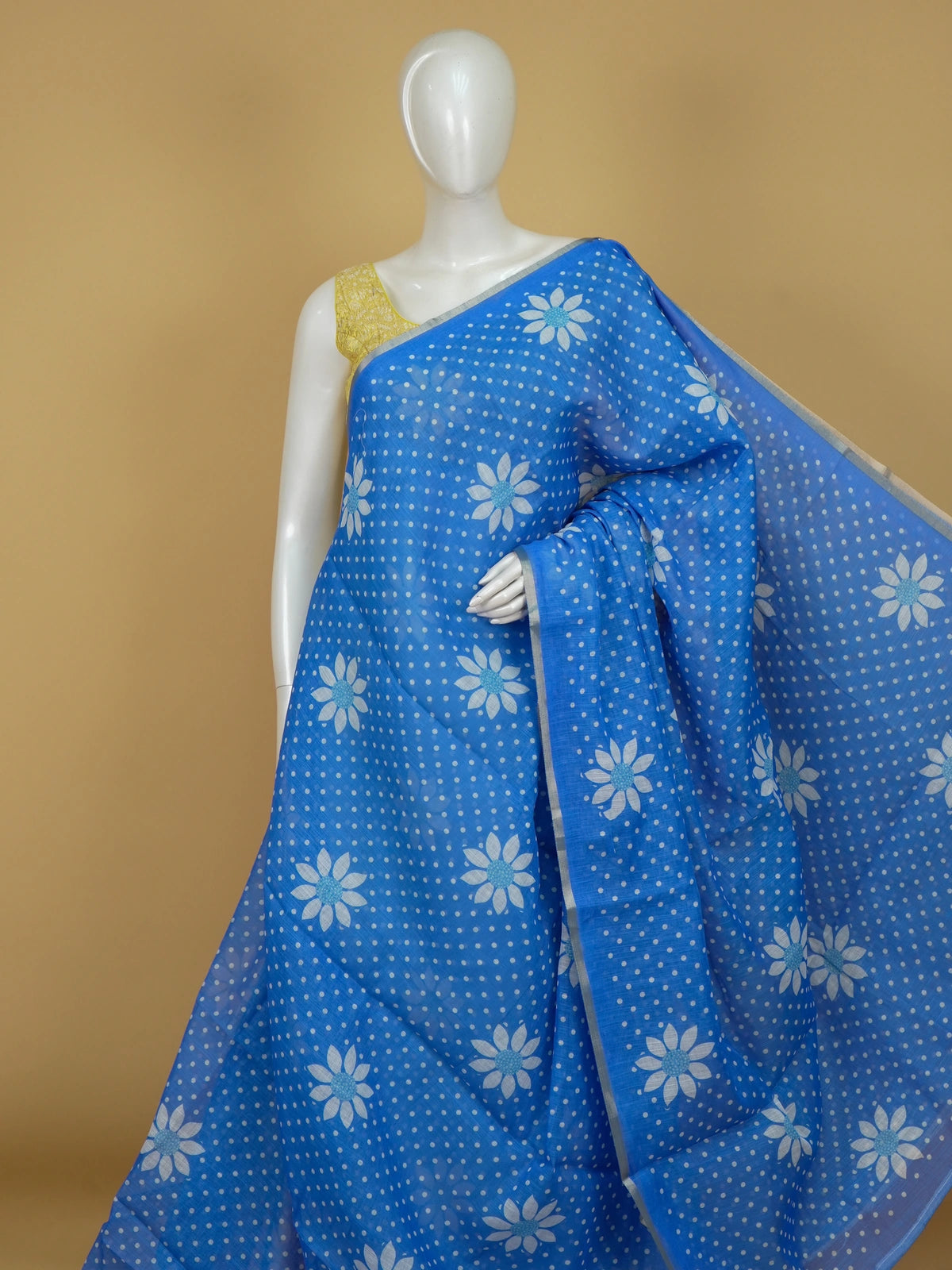 Bright blue linen cotton saree with white polka dots, daisy floral motifs and silver zari border