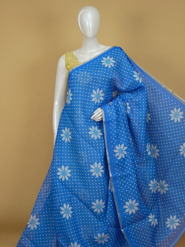 Bright blue linen cotton saree with white polka dots, daisy floral motifs and silver zari border