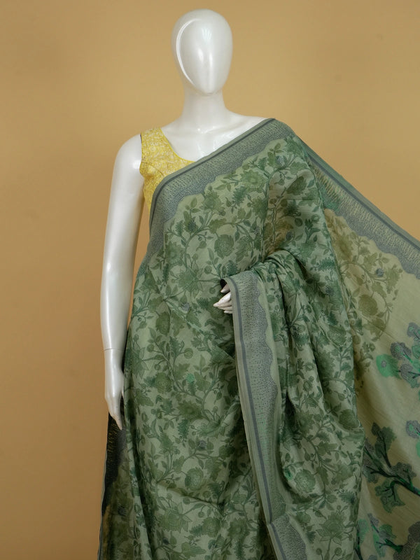 Sage green floral printed linen cotton saree with grey dotted border and tree-motif pallu