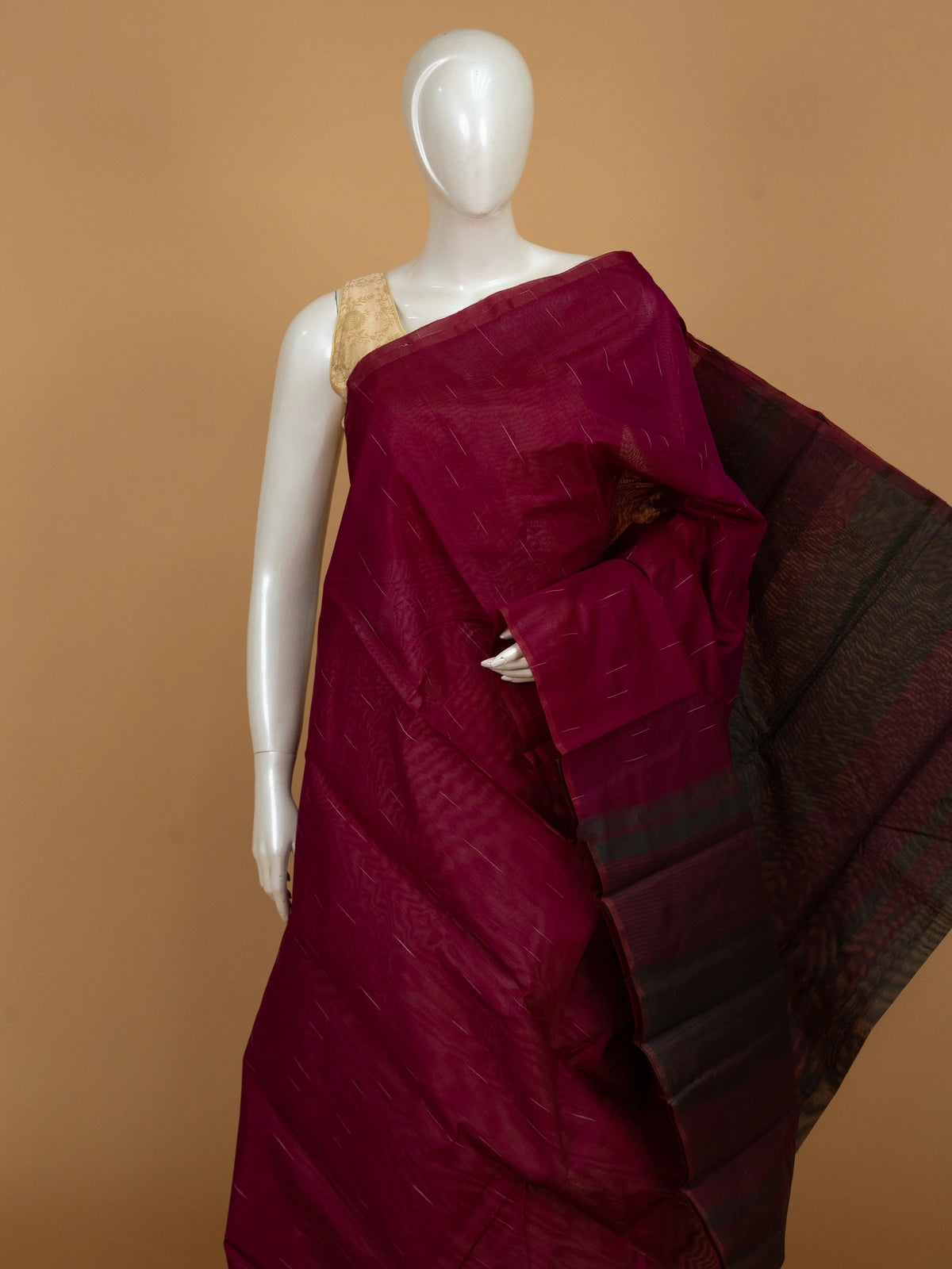 Deep magenta silk cotton saree with fine zari stripes and a dark contrast striped pallu