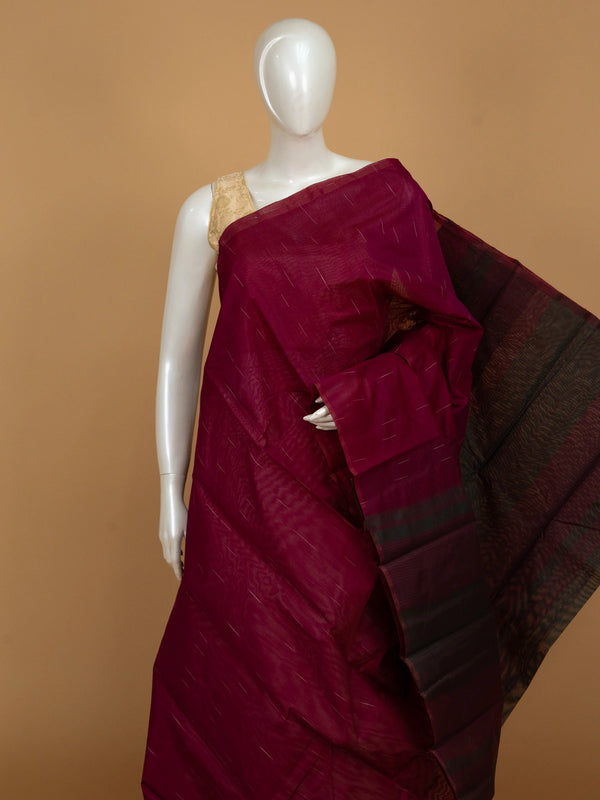 Deep magenta silk cotton saree with fine zari stripes and a dark contrast striped pallu