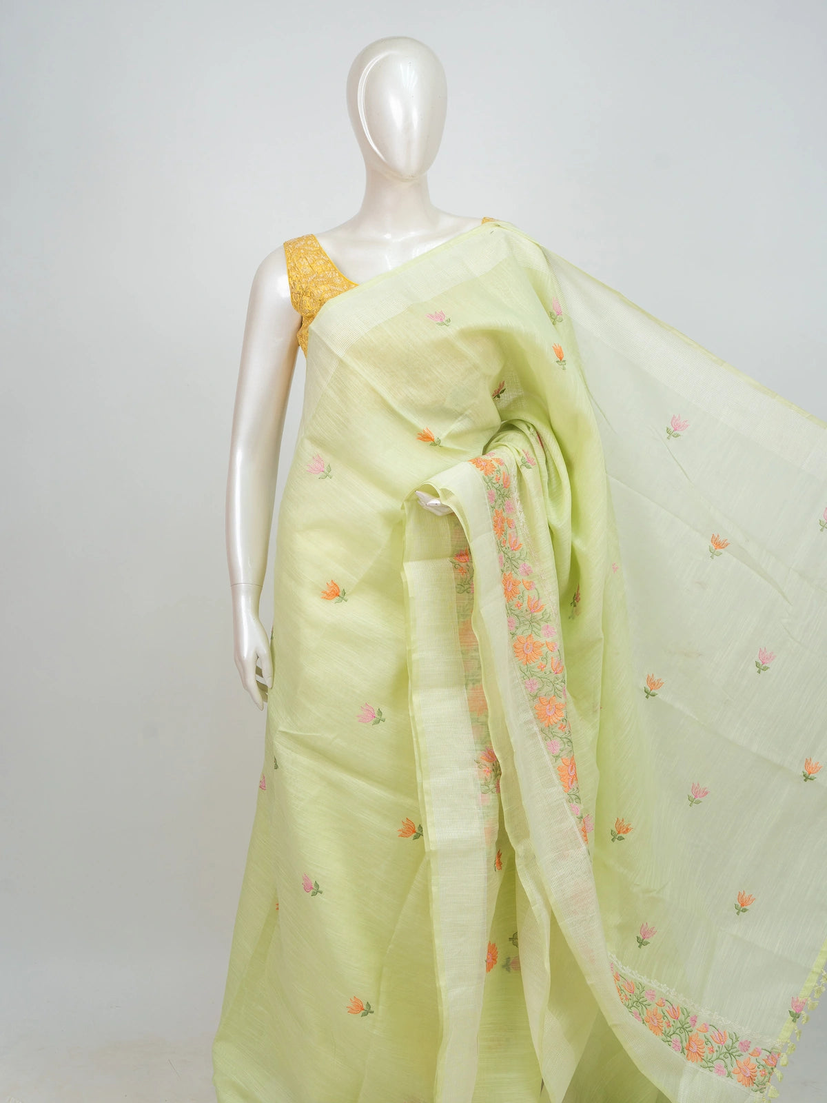Pastel green linen cotton saree with pink and orange floral embroidery and cream contrast border