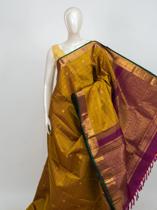 Mustard yellow pure Kanchipuram silk saree with checked body, gold zari buttas and contrast magenta zari border and pallu