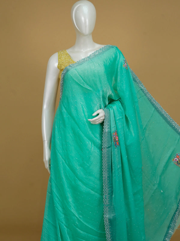 Sea green tissue designer saree with multicolour floral motifs and scalloped silver stone border
