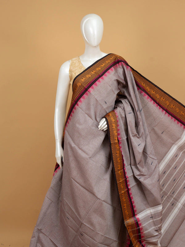 Grey Chettinad cotton saree with mustard and black contrast border, pink temple edging and woven animal motifs