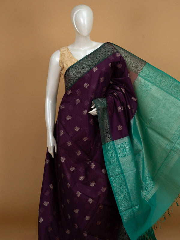 Purple silk cotton saree with teal-green contrast border and gold zari lotus motifs