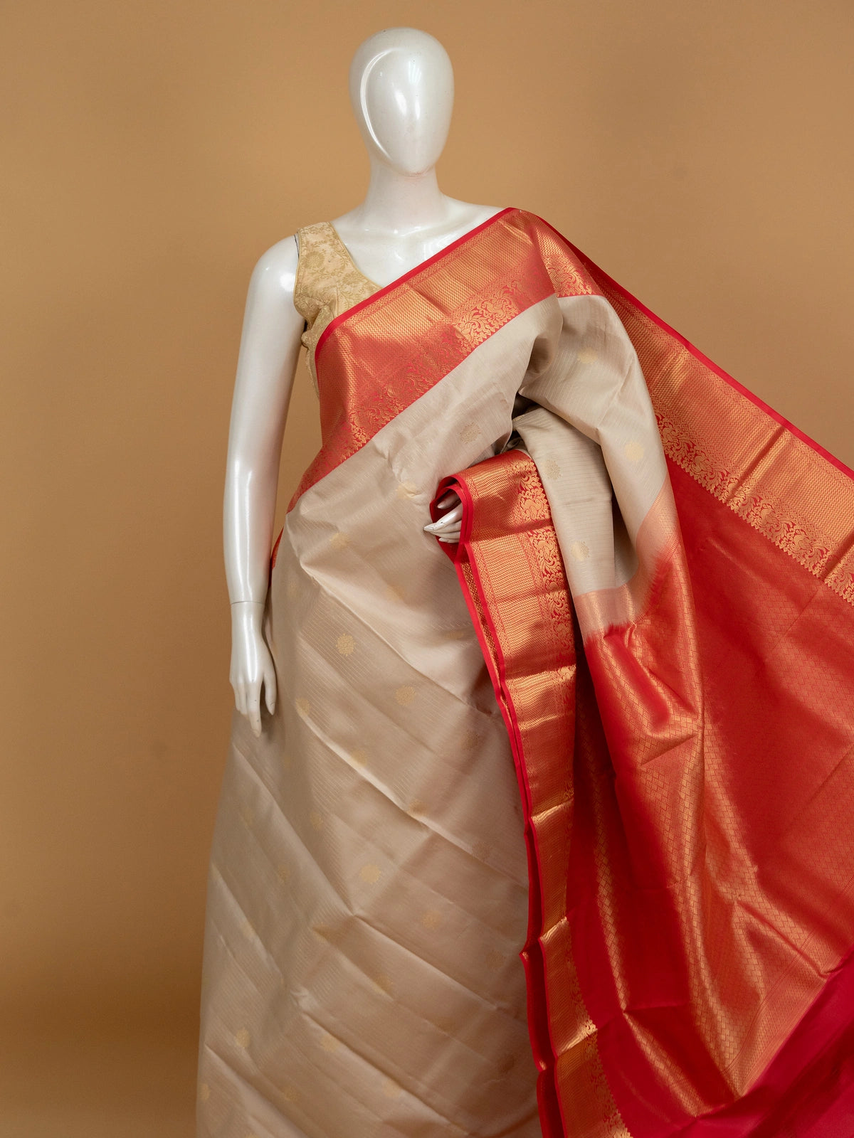 Cream and red pure Kanchipuram silk saree with gold zari border and buttas
