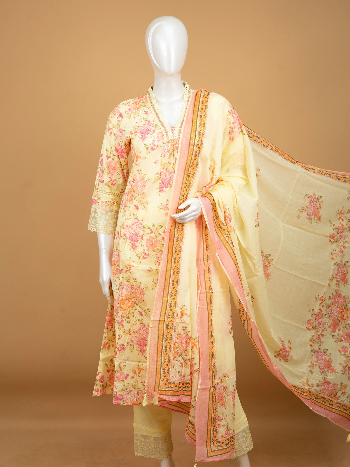 Yellow floral cotton Anarkali kurti set with beaded V-neck, lace cuffs, straight pants, and pink-bordered dupatta