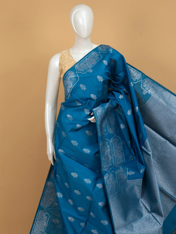 Peacock blue silk cotton saree with silver zari floral buttas and diamond-patterned border