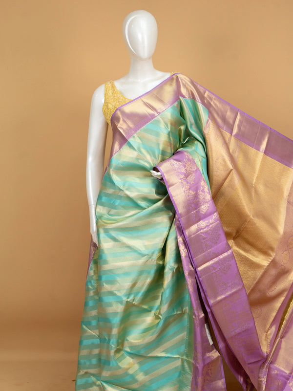 Turquoise green pure Kanchipuram silk saree with diagonal gold zari stripes and contrast lavender zari border