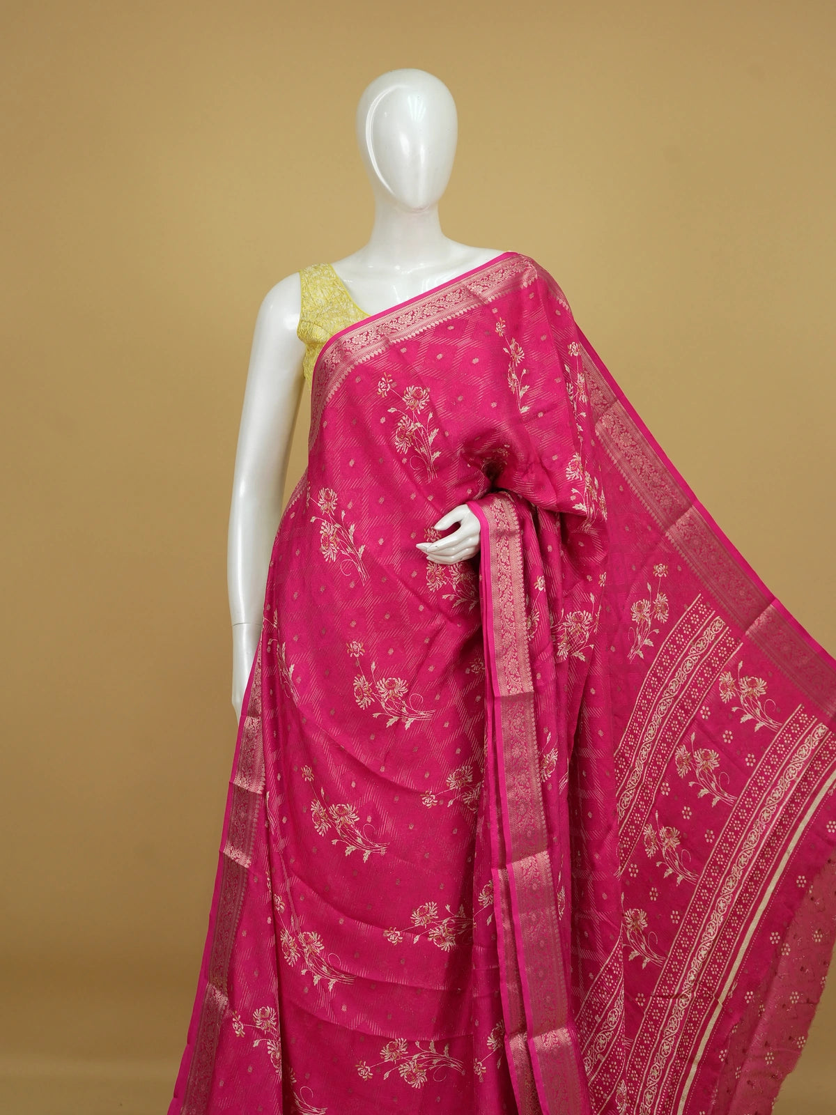 Rani pink designer saree with floral motifs, gold zari butti and woven zari border