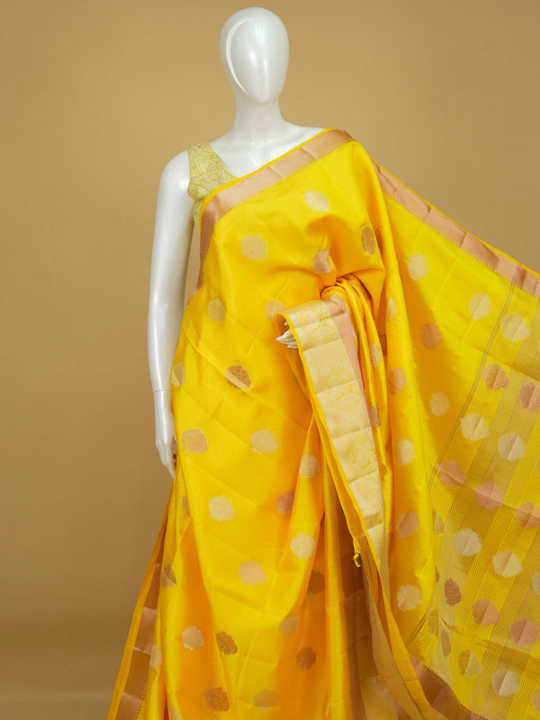 Bright yellow semi tussar saree with silver and gold zari butta motifs and contrast zari border