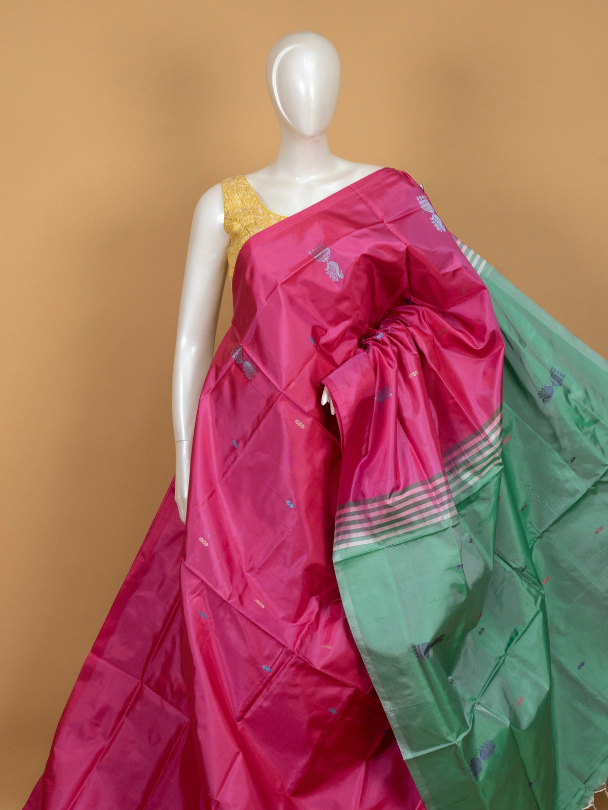 Pink banana silk saree with contrast green pallu and woven peacock motifs