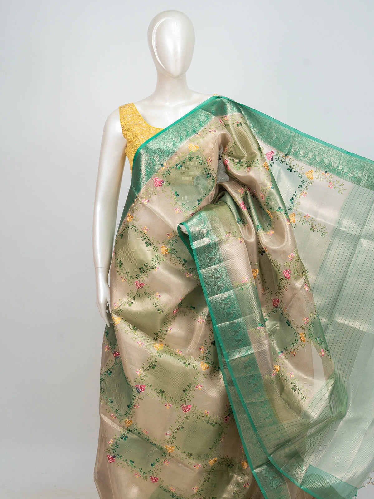 Cream and green semi raw silk saree with multicoloured floral vines and a green zari border