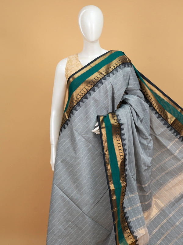 Grey Chettinad cotton saree with fine white stripes and contrast green gold zari temple border