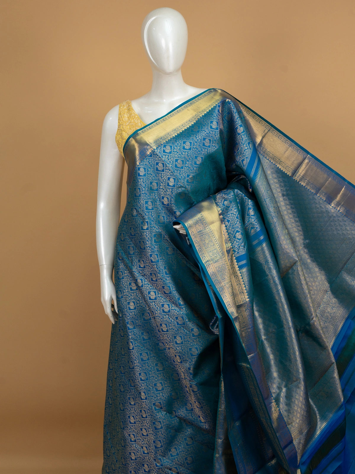 Peacock blue pure Kanchipuram silk saree with all-over gold zari brocade, peacock motifs and broad contrast gold zari border
