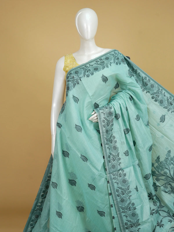 Sea green linen cotton saree with dark teal paisley buttas, floral border and scenic peacock and deer pallu