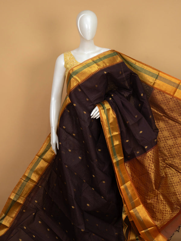 Maroon brown Chettinad cotton saree with mustard-gold zari border, green stripe accents and gold buti motifs