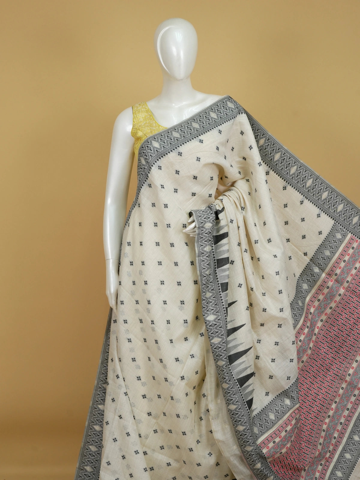 Ivory linen cotton saree with black temple border, floral buttas and pink patterned pallu