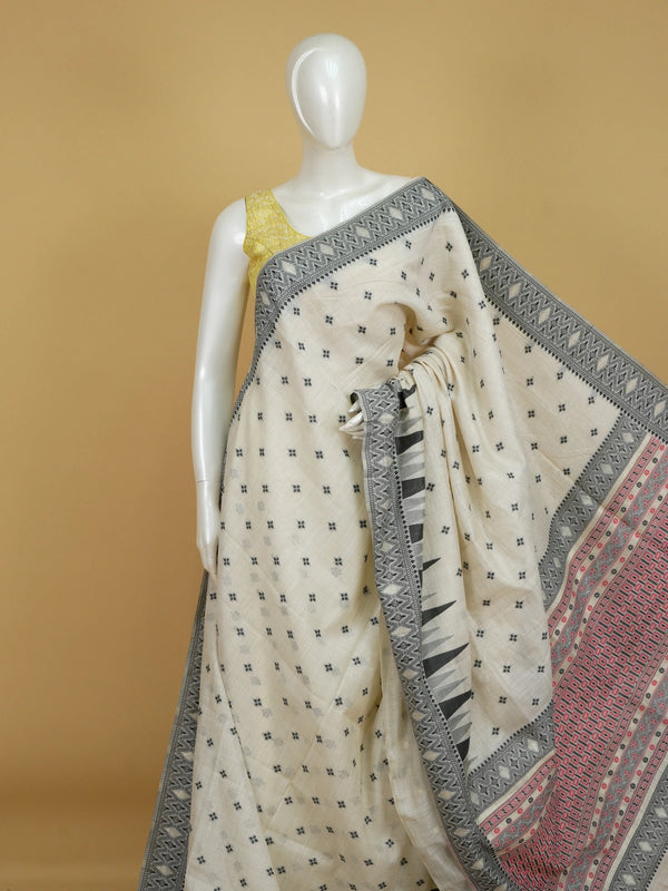 Ivory linen cotton saree with black temple border, floral buttas and pink patterned pallu