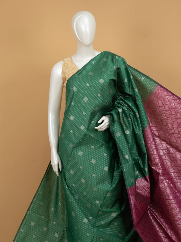 Bottle green silk cotton saree with silver zari stripes and contrast magenta border and pallu