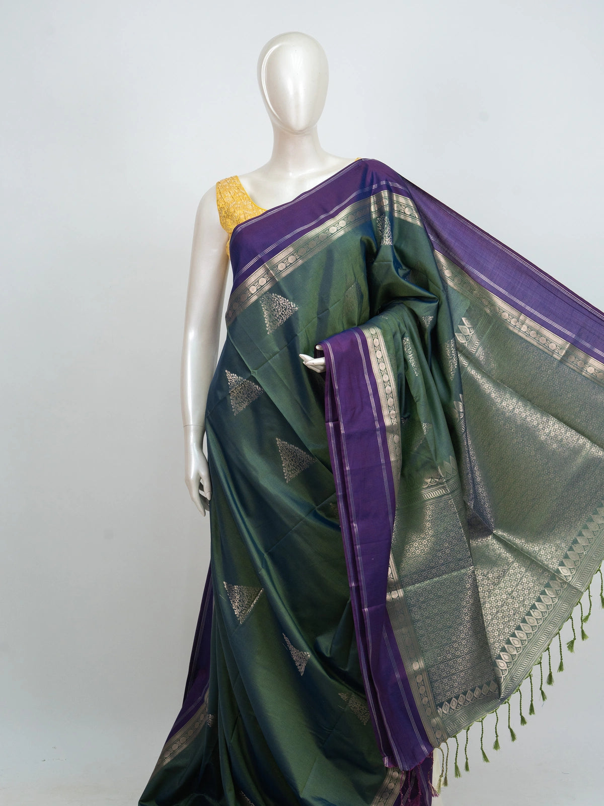 Green Kanchipuram fancy silk saree with contrast purple silver zari border and triangular zari buttas