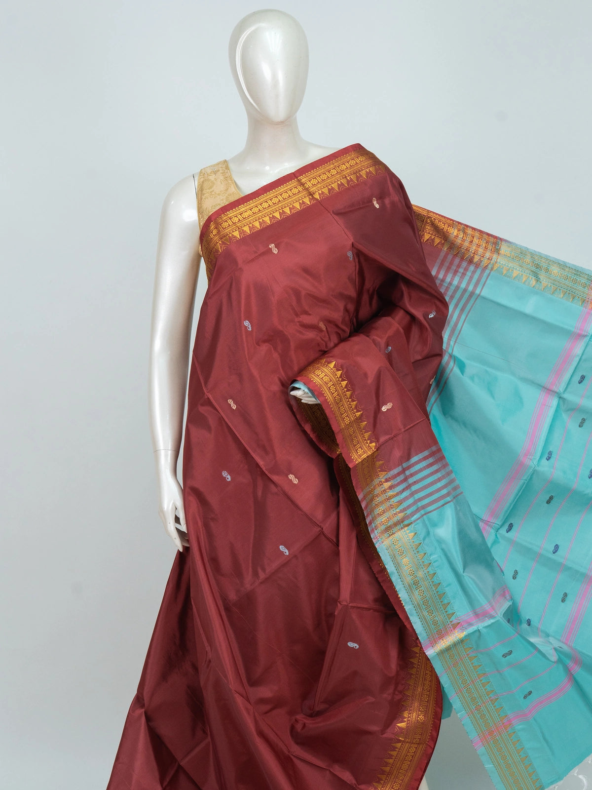 Maroon Banana Silk saree with turquoise contrast pallu and gold zari temple border
