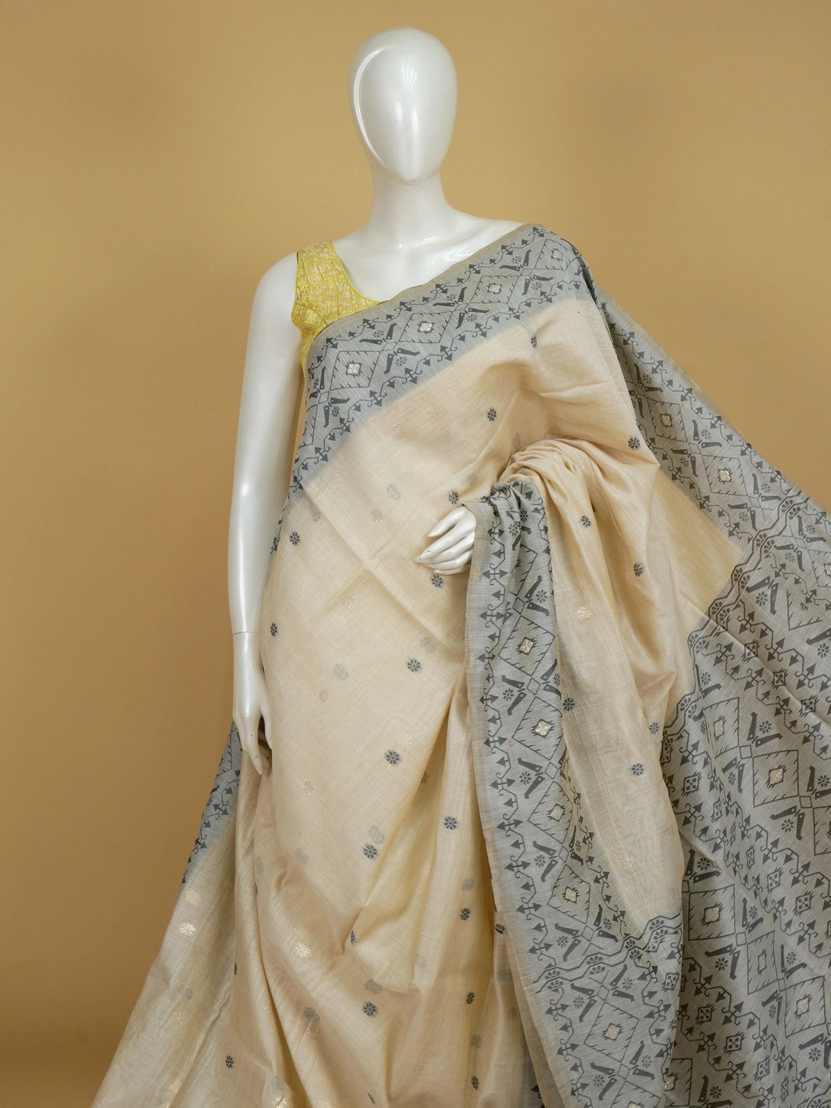 Cream and grey linen cotton saree with geometric grey pallu, border and silver zari floral buttas