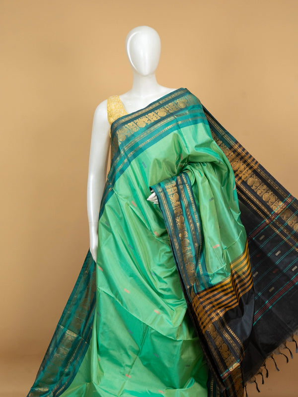 Green Banana Silk saree with teal gold zari peacock border and black striped pallu
