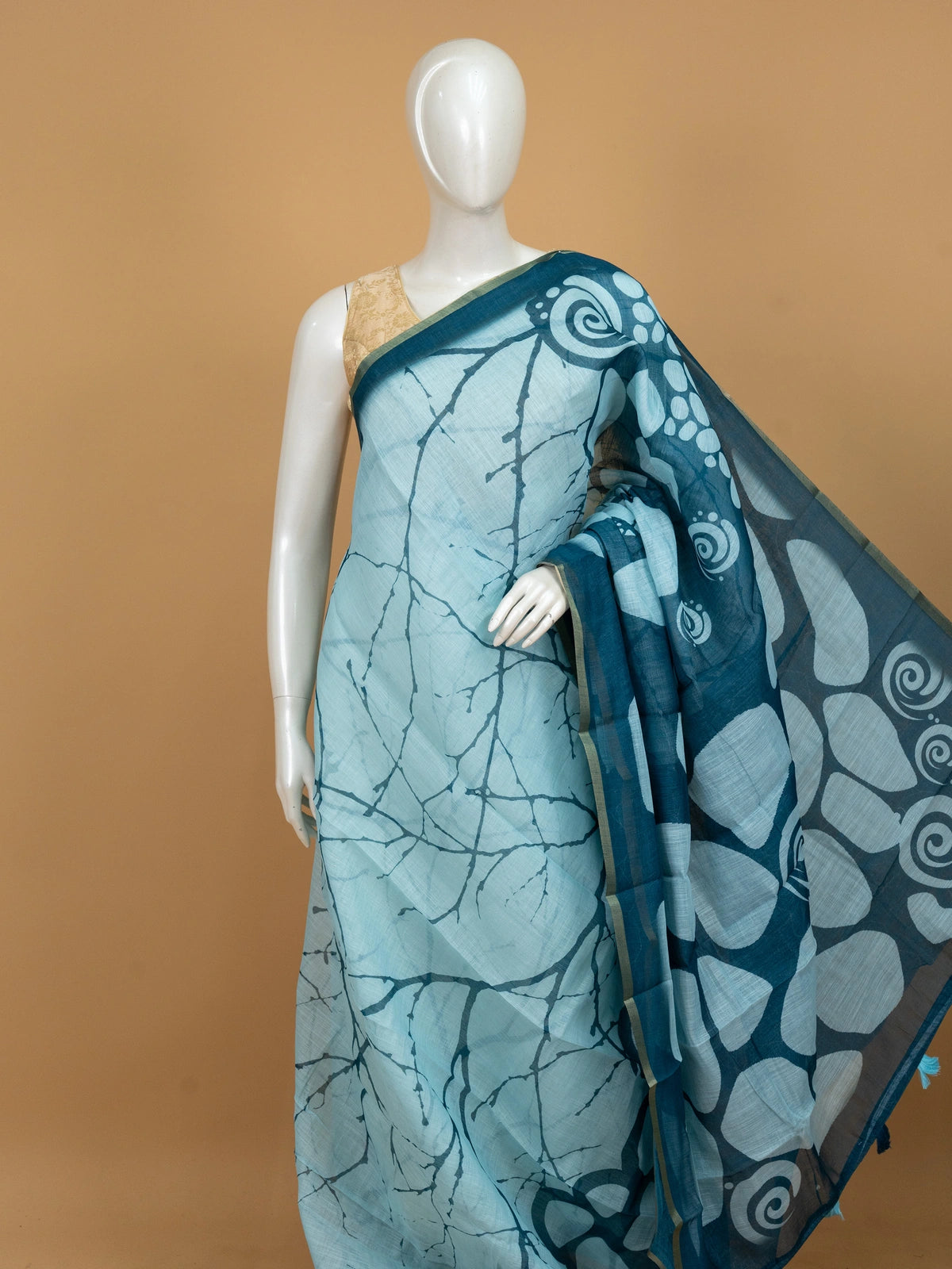 Sky blue and teal batik linen cotton saree with white pebble motifs and gold zari border