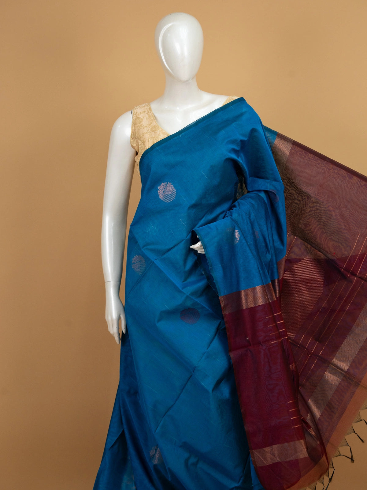 Peacock blue silk cotton saree with maroon contrast zari border and woven butta motifs