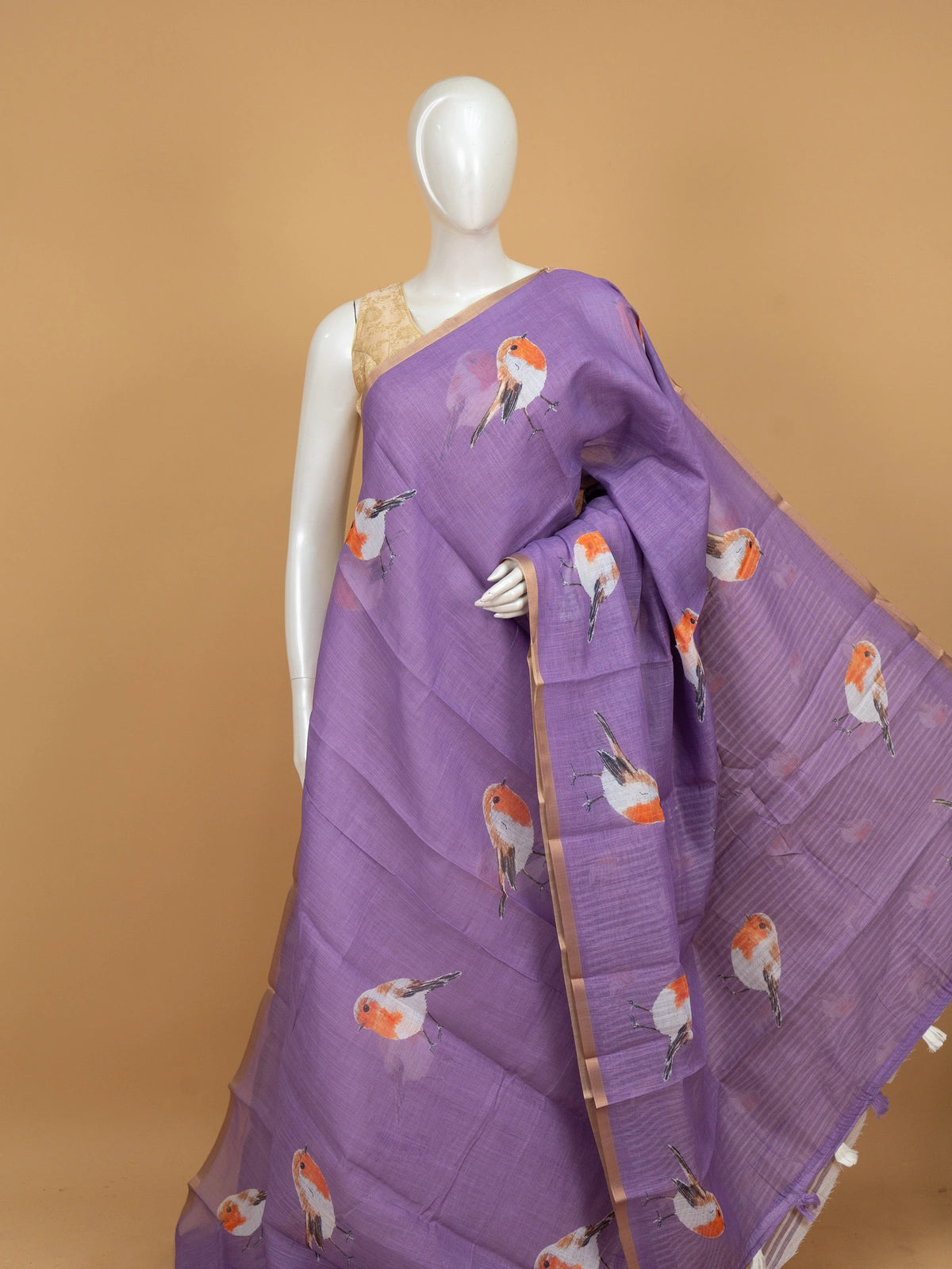 Lavender linen cotton saree with orange and white robin bird prints and gold zari border