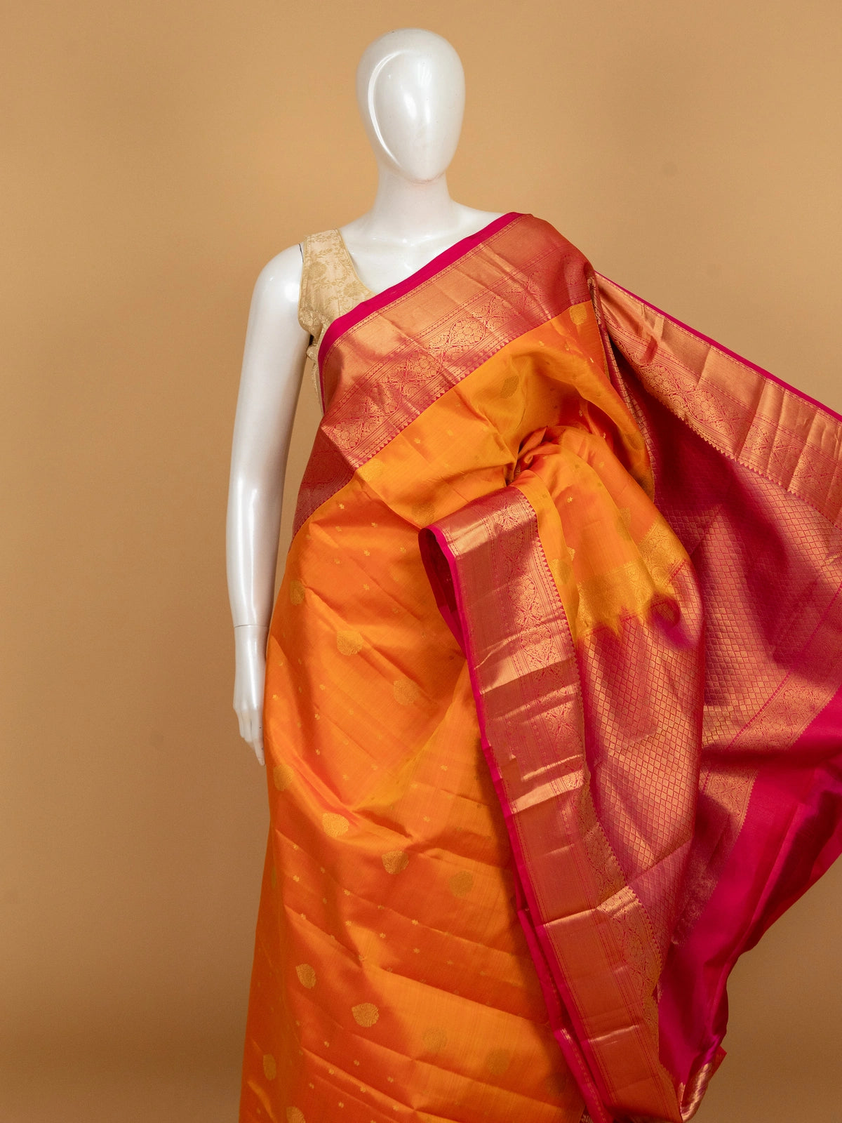 Orange and pink pure Kanchipuram silk saree with gold zari border and zari pallu
